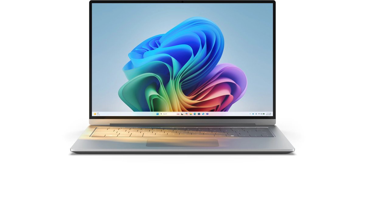 Laptop showing the Windows 11 desktop with the taskbar Search box