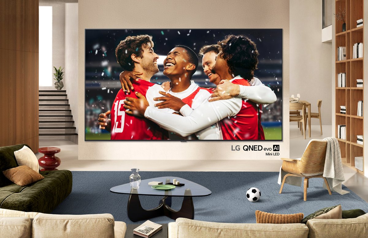 LG QNED Mini LED smart TV displaying content on a wall-mounted screen in a living room