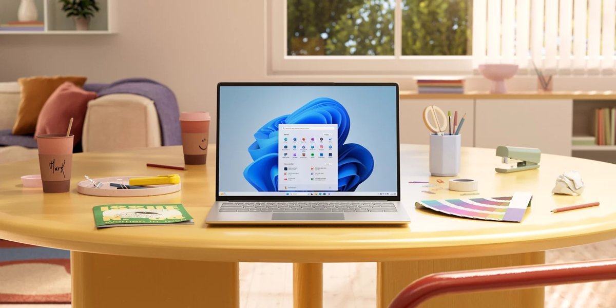Windows 11 laptop open on a desk with the Start menu showing, illustrating Teams and Outlook not opening on ARM Windows 11 PCs